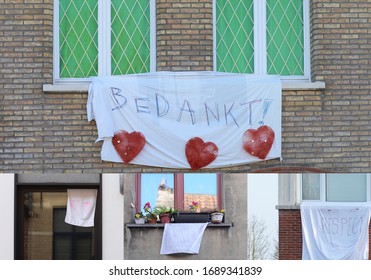 BRUGES, BELGIUM – CIRCA MARCH 2020: White sheets and towels hanging out windows as an expression of support and thanks to people working in healthcare or the white sector during covid-19 pandemic