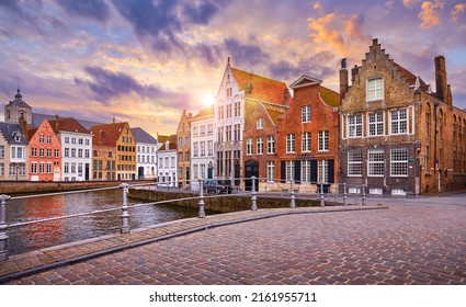 Bruges, Belgium. Historic city center of Brugge, West Flanders province. Evening sunset with ancient medieval architecture of Bruges old town. Canals and stone paving streets cityscape.