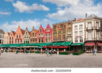 BRUGES, BELGIUM - JUNE 2, 2014. Tourists on street cafes in Bruges, market square Flanders.