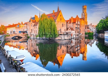 Bruges, Belgium. Rozenhoedkaai in sunrise light, old town with Belfry water reflection, Flanders travel scenics.