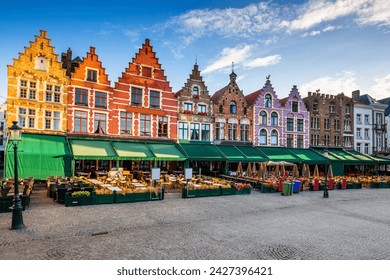 Bruges captivates with its picturesque canals, medieval buildings, and cobblestone streets. This stunning image showcases the iconic landmarks of Bruges, including the majestic Belfry towering 