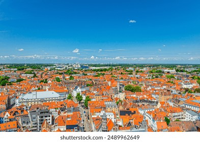 Bruges cityscape aerial panoramic view of Bruges historical city centre with old buildings red tiled roofs, skyline horizon blue sky white clouds, panorama of Brugge old town, West Flanders, Belgium - Powered by Shutterstock