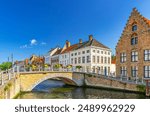 Bruges cityscape, Sint-Annareibrug stone Bridge, Sint Annarei water canal of Reie river, medieval buildings in Bruges city historic centre, embankment in Brugge old town, Flemish Region, Belgium