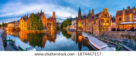Brugge city centre, often referred to as The Venice of the North, with famous Rozenhoedkaai illuminated in beautiful twilight, West Flanders province, Belgium