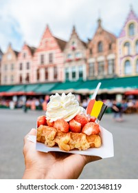 Brugge waffles Belgium, Waffle with cream and strawberry, waffle isolated in hand in Brugge Belgium