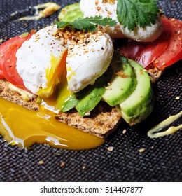 Brunch Idea; Whole Grain Crispy Bread Spread With Mustard And Mayonnaise Topped With Slice Avocado, Tomato And Poached Egg. Garnished With Parsley, Grilled Sesame Seed, Seaweed And Chili Powder.