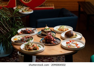 Brunch Meals On Wooden Table, Side View Of Served Round Table