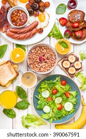 Brunch party. Assortment of breakfast choices. English breakfast, sausages, fried eggs, bacon, salad, granola, cheese sandwich, pancakes, chocolate cream and banana toast, coffee, fresh orange juice - Shutterstock ID 390067591