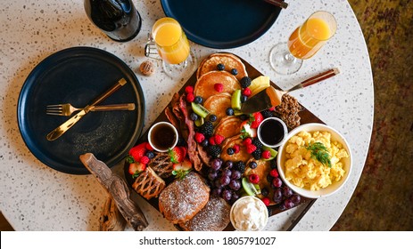 Brunch platter with pastries, pancakes and berries - Shutterstock ID 1805791027