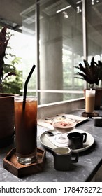 Brunch With Pudding And Coffee In The Cafe With Aesthetic Interior.