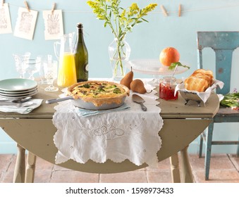 Brunch Table Set Up With Quiche Grapefruit And Prosecco