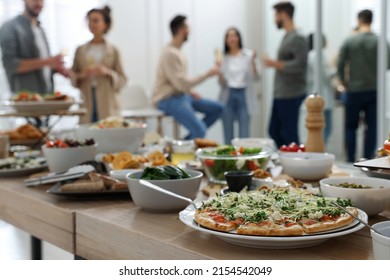 Brunch table setting with different delicious food	and blurred view of people on background - Powered by Shutterstock