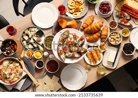 Brunch table setting with different delicious food indoors, top view