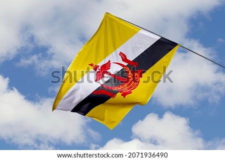 Brunei flag isolated on sky background. close up waving flag of Brunei. flag symbols of Bruneian.