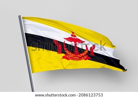 Brunei's flag is isolated on a white background. flag symbols of Brunei. close up of a Bruneian flag waving in the wind.