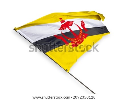 Brunei's flag is isolated on a white background. flag symbols of Brunei. close up of a Bruneian flag waving in the wind.