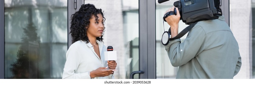 Brunette African American Journalist Doing Reportage Near Cameraman Outside, Banner