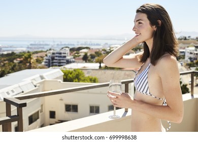 Brunette Babe In Bikini Relaxing With Wine On Balcony, Smiling