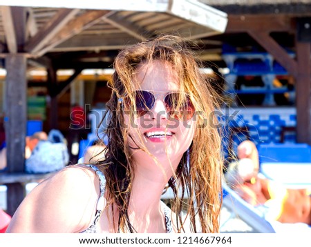 Brunette beautiful disheveled hair portrait on the beach hairstyle