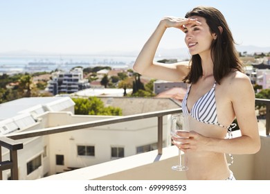 Brunette Bikini Babe On Balcony With Wine, Looking Out