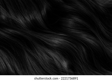 Brunette or black hair. Female long dark hair in black. Beautifully laid curls. Closeup texture in a dark key. Hairdressing, hair care and coloring. Shading gray hair. Background with copy space. - Shutterstock ID 2221736891