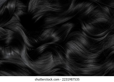 Brunette or black hair. Female long dark hair in black. Beautifully laid curls. Closeup texture in a dark key. Hairdressing, hair care and coloring. Shading gray hair. Background with copy space. - Shutterstock ID 2231987535