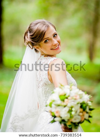 Brunette bride poses with bouquet