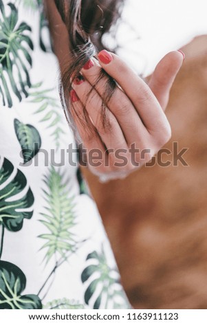 Similar – Image, Stock Photo Young woman wearing a flower shirt and using her phone