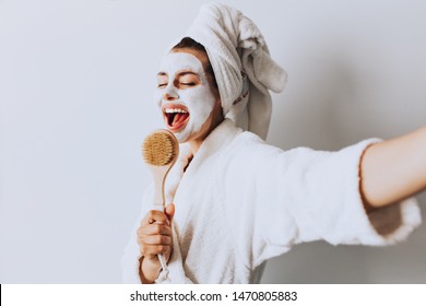 
Brunette Cute Young Girl Female Woman Singing  With Refreshing Spa Body Care Mask Doing Selfie In Light Room At Home. Morning Wake Up / Body Care Concept