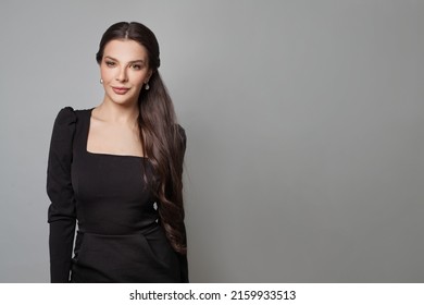 Brunette Female Model In Black Dress Smiling On Gray Banner Background