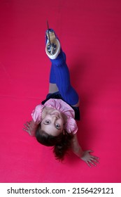 Brunette Figure Skater Girl On Pink Artificial Ice