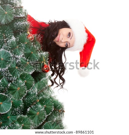 brunette funny woman behind the artificial fur tree