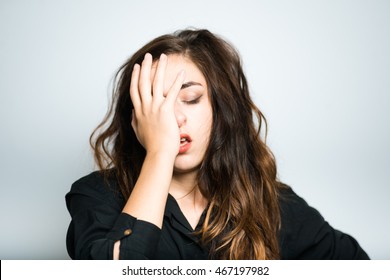 brunette girl is bored, dressed in black, isolated on white background - Shutterstock ID 467197982