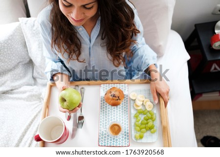 Similar – Gesundes Frühstück auf Tablett und im Hintergrund liegendes Paar