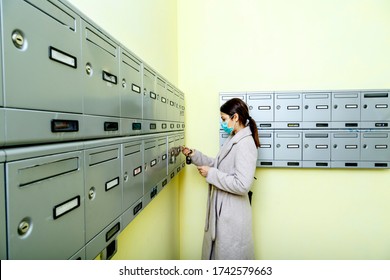 Brunette Girl With Coat Checks Mail In Mailbox Protective Face Mask