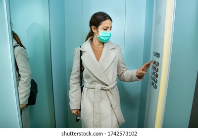 brunette girl with coat takes the elevator wearing the protective face mask - Powered by Shutterstock