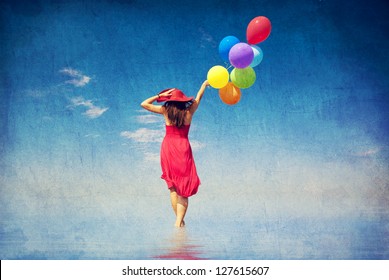 Brunette Girl With Colour Balloons At Coast. Photo In Old Color Image Style.