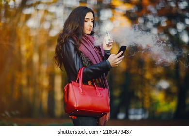 Brunette Girl Is Smoking An E-cigarette