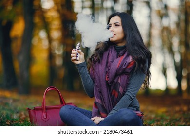 Brunette Girl Is Smoking An E-cigarette