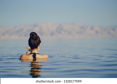 Brunette Girl Swimming In The Dead Sea In Israel