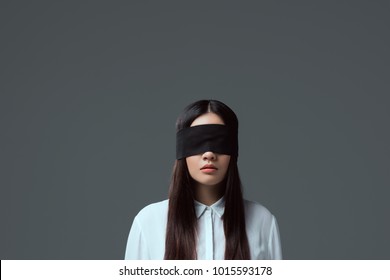 Brunette Girl Wearing Black Blindfold Isolated On Grey