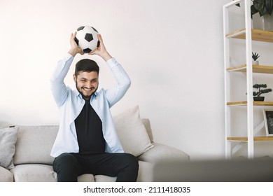 Brunette Guy Sitting On A Coach And Watching Football At Home