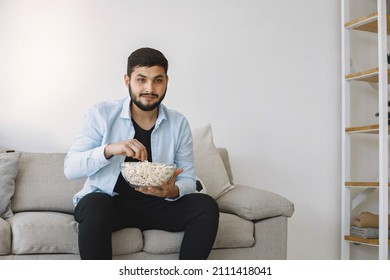 Brunette Guy Sitting On A Coach And Watching Football At Home