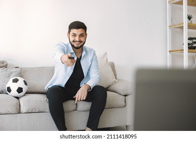 Brunette Guy Sitting On A Coach And Watching Football At Home