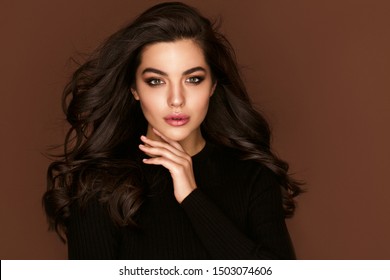 Brunette haired Woman Portrait with brown eyes and Healthy Long Shiny Wavy hairstyle. Volume shampoo. Black Curly permed Hair and bright makeup.  Beauty salon and haircare concept. - Shutterstock ID 1503074606