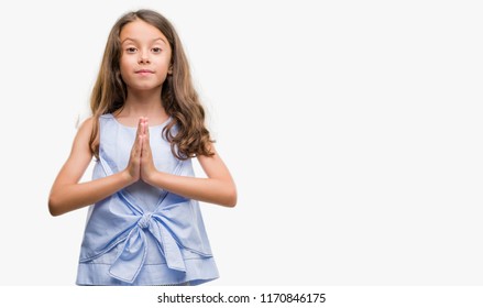 Brunette Hispanic Girl Praying With Hands Together Asking For Forgiveness Smiling Confident.