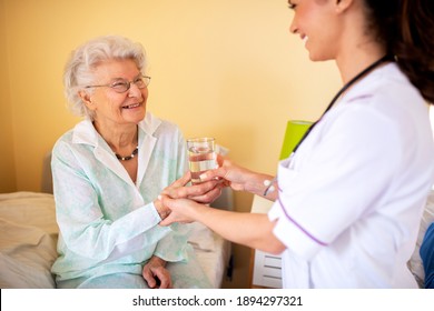 Brunette Lady Doctor And Her Nursing Home Elder Woman Patient Having Polite Conversation, Skilled Nursing Facility Concept