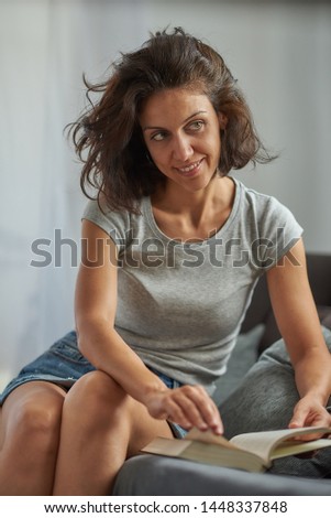 Similar – Young female sitting by table and making clay or ceramic mug in her working studio