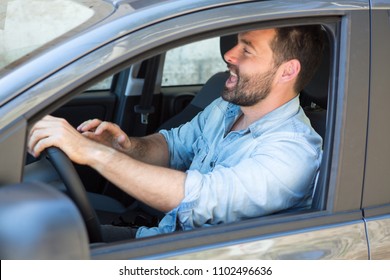 Brunette Man In A Car Singing