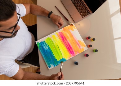 Brunette Man Painting Color Screen In Front Of His Computer, Practicing Art Therapy.